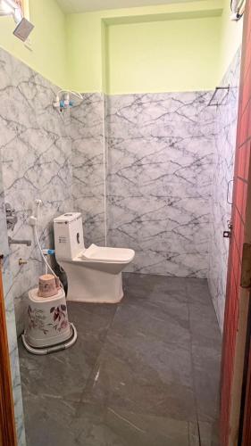 a bathroom with a shower and a toilet in it at pnrpalace in Bāpatla