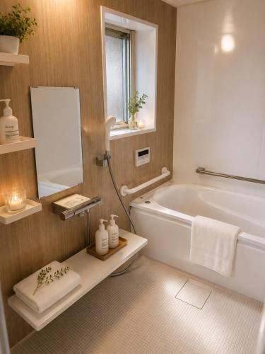 a bathroom with a white tub and a mirror at 貸切り200m2 林檎のワルツ 広い和モダン邸宅 星空とBBQ in Komoro