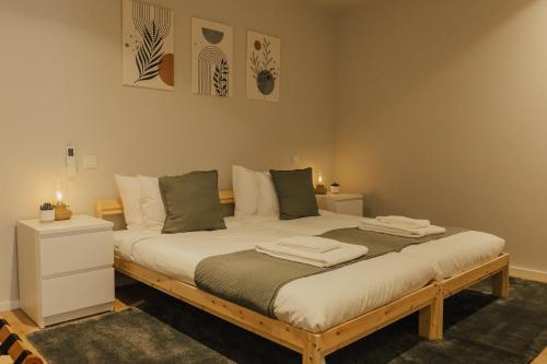 a bedroom with a large bed with towels on it at Gerês Thermae Retreat in Geres