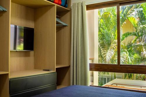 a bedroom with a bed and a large window at Casa BACO - Morro de São Paulo in Cairu