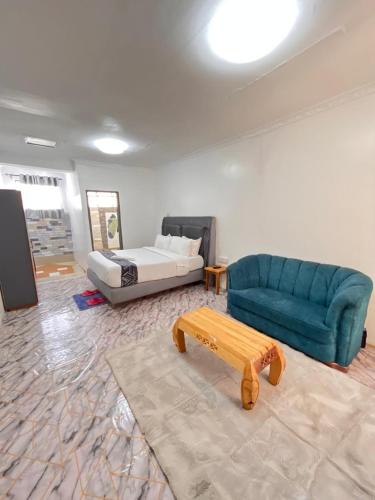 a living room with a couch and a bed at VIJIJI HOTEL & CONFERENCE in Eldoret