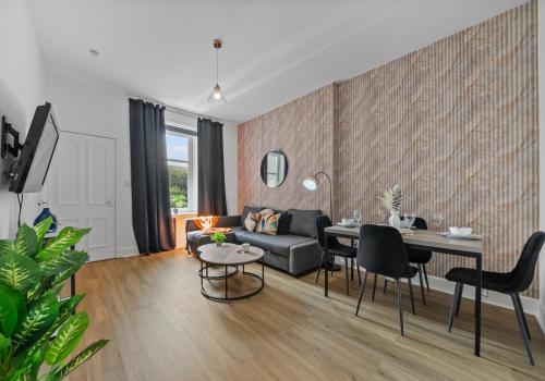 a living room with a couch and a table at Albion Apartment by Klass Living Coatbridge in Coatbridge
