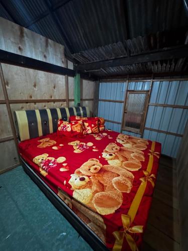 a bedroom with a bed with teddy bears on it at Jufri Homestay in Kasijala