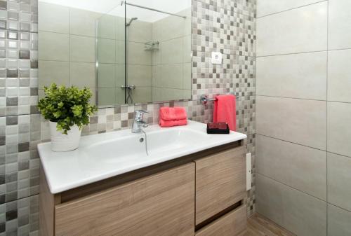 a bathroom with a sink and a mirror at Famara Marea 2 in Famara