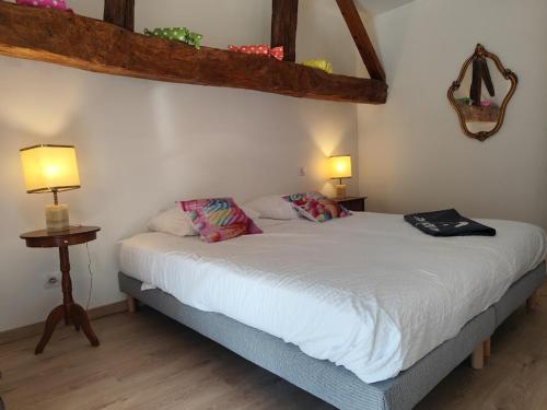 a bedroom with a bed with two pillows on it at Candyland in Argançon