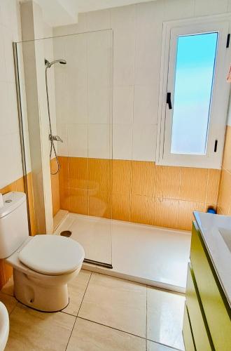 a bathroom with a toilet and a shower at Los Barqueros Suites Palm in Corralejo