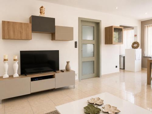a living room with a flat screen tv at apartment 2 miles from Maastricht in Lanaken