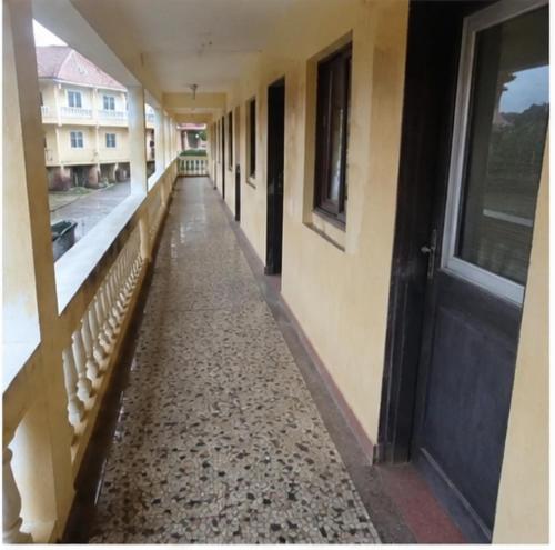 an empty hallway of a building with a black door at NH hôtel in Antananarivo
