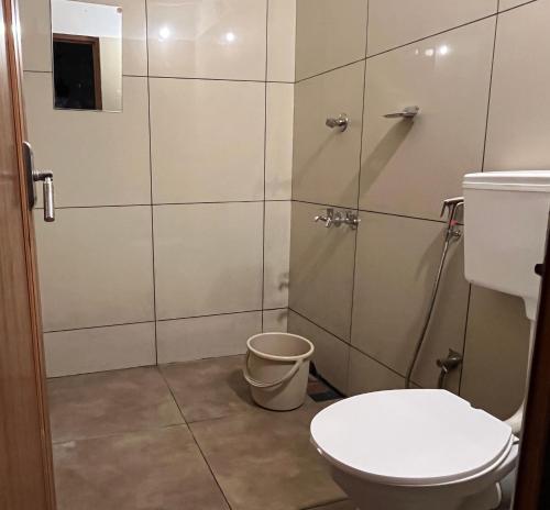 a bathroom with a toilet and a shower at Coliveinn in Ernakulam