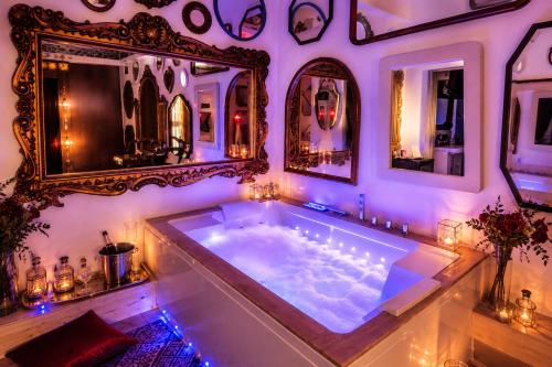a large tub in a room with mirrors at Pupi Catania Etna Farm in Catania