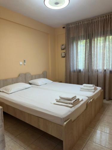 a bedroom with a large bed with towels on it at Villa Malila in Panagia