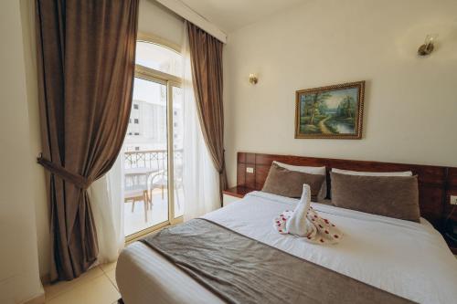 a bedroom with a bed with a window at Fantasia Hotel in Hurghada