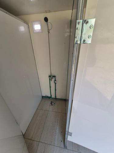 an empty room with a shower in a wall at Willage camp i auto camp KOMARNICA in Šavnik