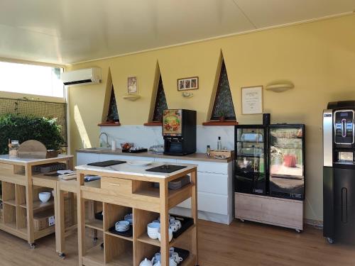a kitchen with a counter and a refrigerator at Le Mas De Gaujac in Lézignan-Corbières