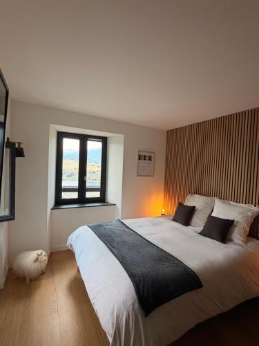 a bedroom with a large bed and a window at Refuge d'Odeillo Vue lac Luxe 8 pers Les Angles in Réal