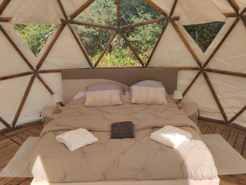 a bedroom with a large bed in a yurt at La Grande Grange 89 in Saint-Martin-des-Champs
