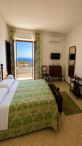 a bedroom with a bed and a view of the ocean at Pupi Catania Etna Farm in Catania