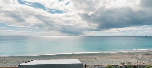 a view of the beach and the ocean on a cloudy day at Yawen Homestay 雅文民宿 in Lanyu