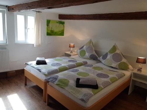 a bedroom with a bed with two tables and two windows at Ferienhaus Nr. 10 in Buergstadt