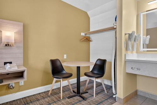 a room with a table and two chairs at Seaside Inn Monterey in Seaside