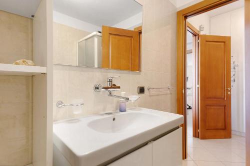 a bathroom with a white sink and a mirror at Appartamento Venere in villa 15pax in Marina di Ragusa