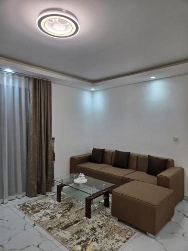 a living room with a couch and a table at Résidences Laurence in Bingerville