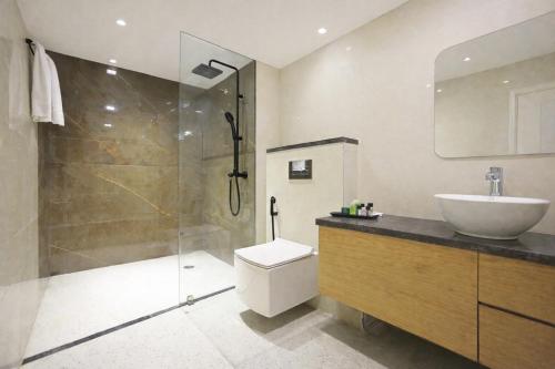 a bathroom with a toilet and a sink and a shower at Hotel Luxury Inn Delhi Airport in New Delhi