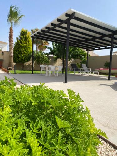 a pavilion with tables and chairs in a park at Laguna del Flamenco in Torrevieja