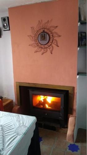 a living room with a fireplace with a mirror on the wall at La Muralla in Yunquera