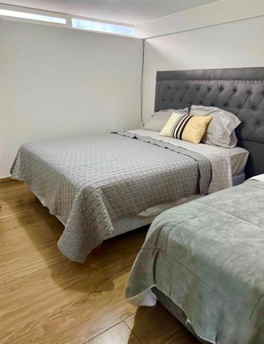 a bedroom with two beds in a room at Premium House in Comodoro Rivadavia