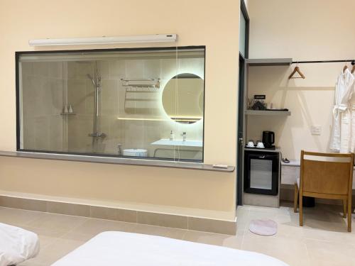 a bathroom with a large glass window with a sink at Samphia Homestay in Nguyệt Hòa
