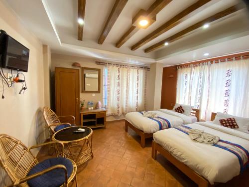 a hotel room with two beds and a tv at Kathmandu Metro Boutique Hotel in Kathmandu