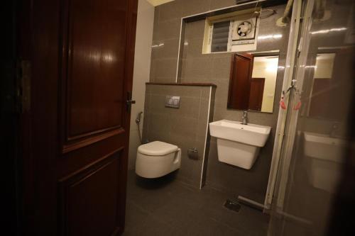 a small bathroom with a toilet and a sink at StarlightHotels ARResidency in Chennai