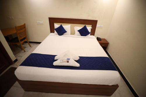 a bedroom with a bed with two towels on it at StarlightHotels ARResidency in Chennai