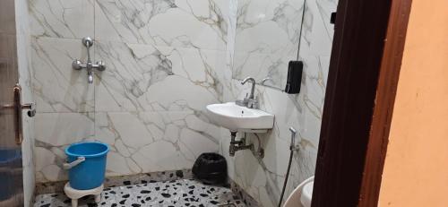 a bathroom with a sink and a toilet at Krishna's land Homestay in Vrindāvan