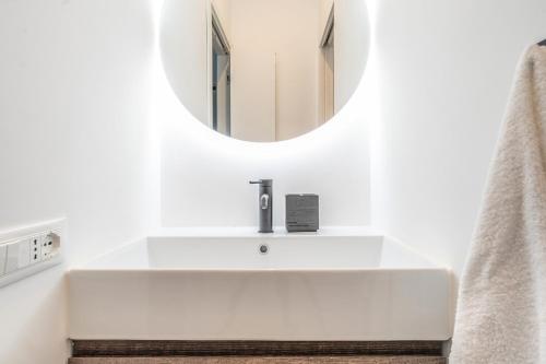 a bathroom with a white sink and a mirror at Casa Eos in Bari