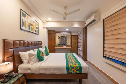 a bedroom with a bed and a flat screen tv at Treebo Planet Mount Near US Consulate Anna Salai in Chennai