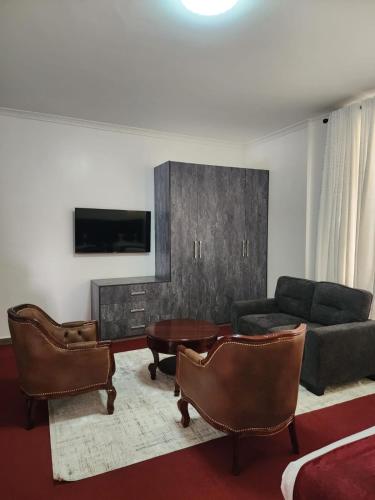a living room with a couch and a table at GRANADA HOTEL NAIROBi in Nairobi
