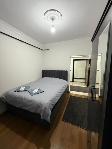 a small bedroom with a bed and a hallway at suite palace in Kapullu