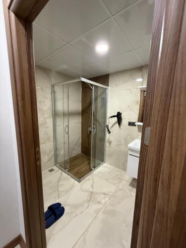a bathroom with a shower and a toilet at suite palace in Kapullu