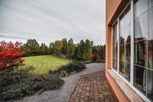 a view of a yard from a window of a house at Hide Away in a Private Countryside Villa in Prestranek