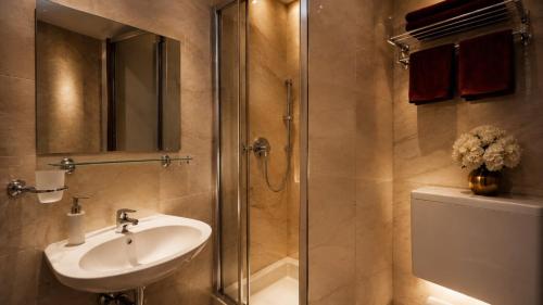 a bathroom with a sink and a glass shower at Hotel AI Königshof in Berlin