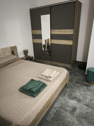 a bedroom with a bed and a large mirror at Due Orizzonti in Monsampolo del Tronto