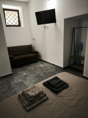 a living room with a couch and towels on the floor at Due Orizzonti in Monsampolo del Tronto