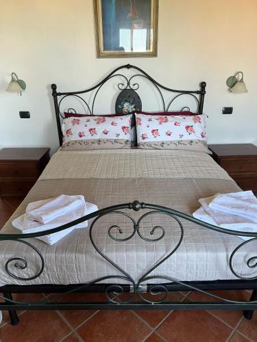 a bedroom with a large bed with red pillows at A casa di Leyla in Monteluro
