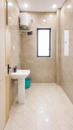 a bathroom with a sink and a window at Mountain top farmhouse in Gurgaon