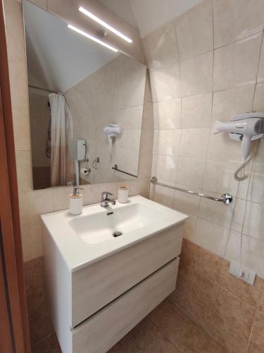 a bathroom with a white sink and a mirror at Cuore di casa Apartment in Terlizzi