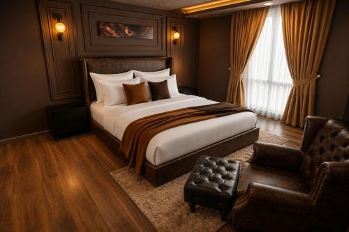 a bedroom with a large bed and a chair at Gold Crest Signature Boutique Apartments With City Views -DHA PHASE 4 LAHORE in Lahore