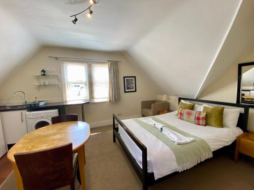 a bedroom with a bed and a table in it at Noa Residence in Oxford
