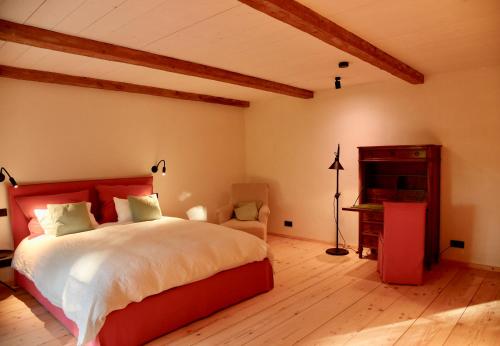 a bedroom with a large bed and a piano at Das versteckte Nest in Seeon-Seebruck